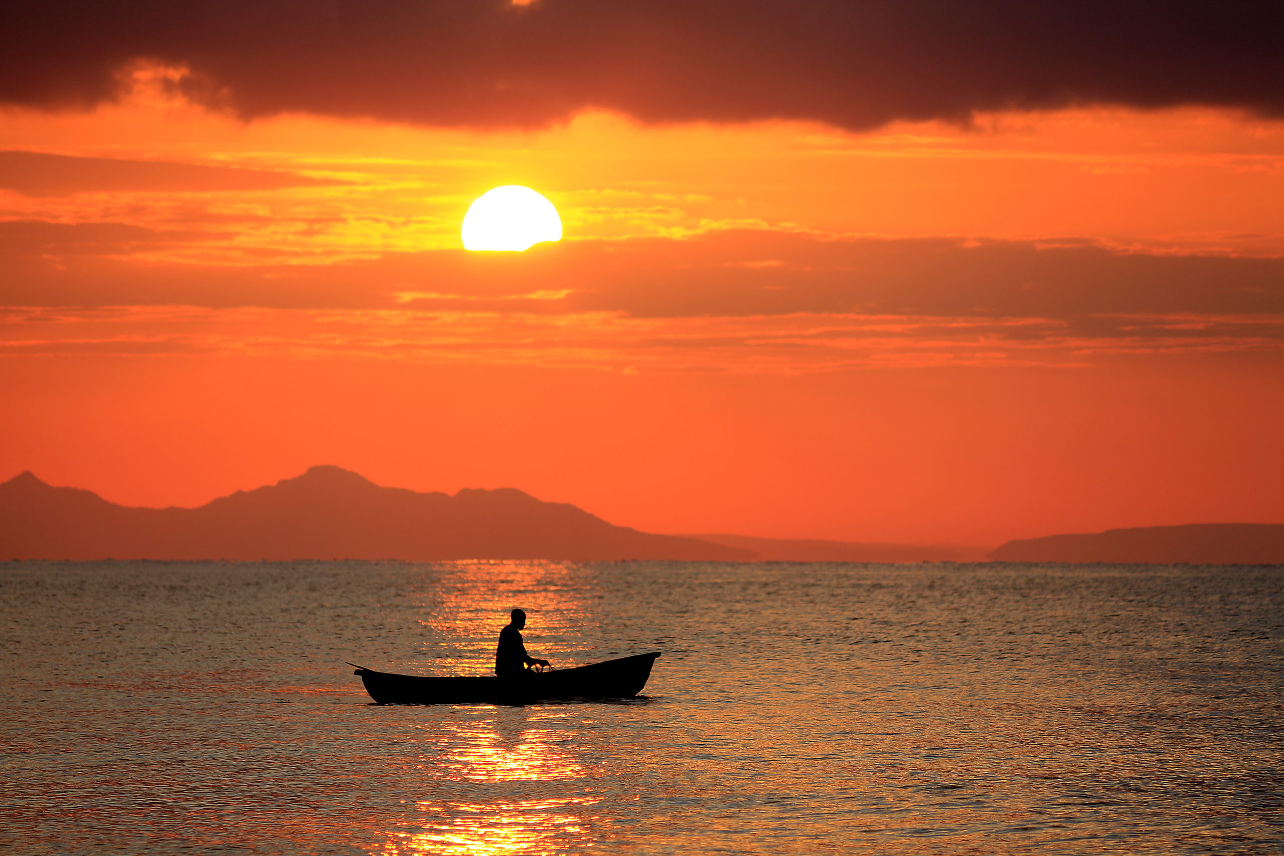 Sunset sunrise lake Malawi fisherman boat fishing Africa water people